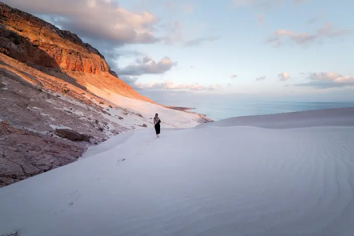 a person standing on top of a snow covered slope